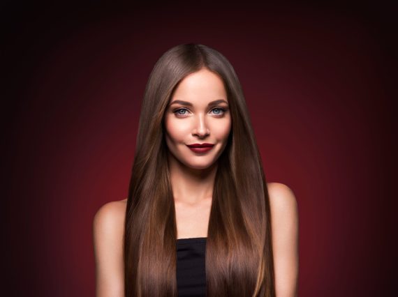 Beautiful hair woman long smooth brunette hairstyle beauty healthy hair female model portrait.  Studio shot.