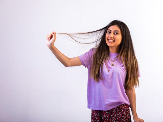 Female model putting her hand on her hair and having fun. High quality photo